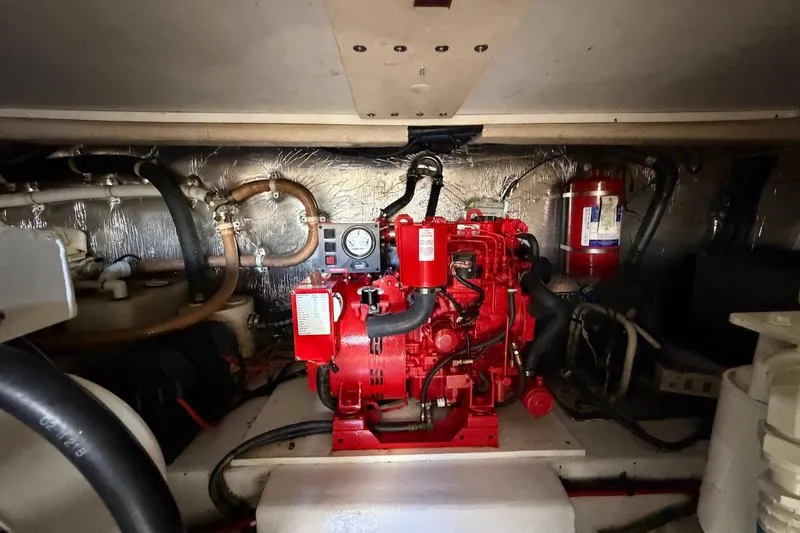 Slide: The Image of Engine room of 2005 Riviera 37 Flybridge with red machinery and piping. - 25