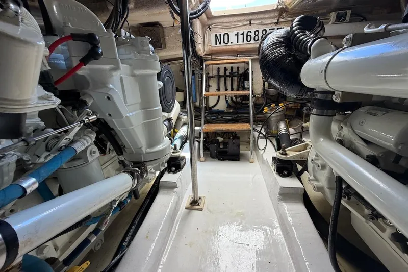 Slide: The Image of Engine room of a 2005 Riviera 37 Flybridge yacht, showcasing mechanical components. - 26