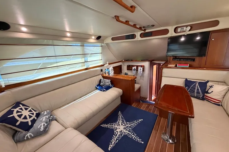 Slide: The Image of Luxurious interior of 2005 Riviera 37 Flybridge yacht with nautical-themed decor. - 7