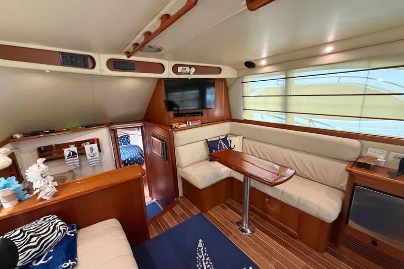 Slide: The Image of Luxurious interior of 2005 Riviera 37 Flybridge yacht with cozy seating and elegant decor. - 8