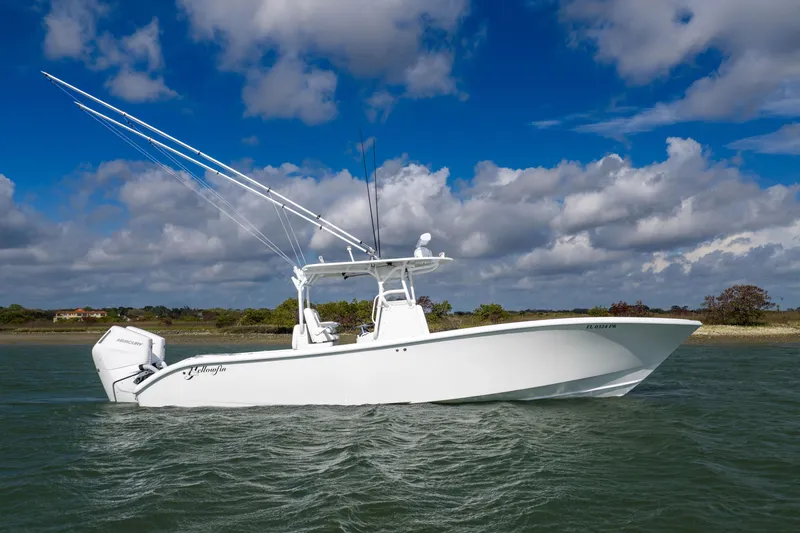 The Image of 2014 Yellowfin 32 Offshore boat on water under blue sky. - 1