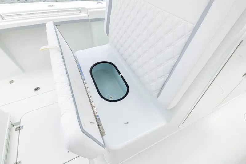 Slide: The Image of 2014 Yellowfin 32 Offshore boat with open storage compartment and quilted seating. - 11