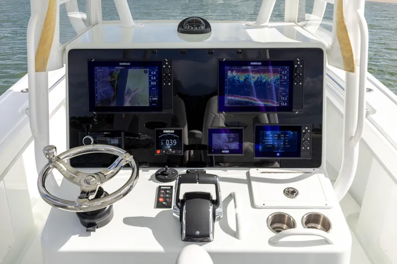 Slide: The Image of 2014 Yellowfin 32 Offshore boat dashboard with advanced navigation displays and controls. - 20