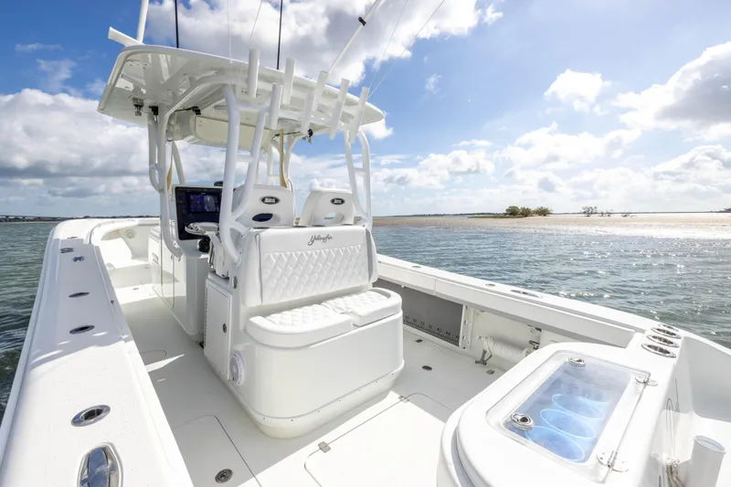Slide: The Image of 2014 Yellowfin 32 Offshore boat on calm waters under a sunny sky. - 22