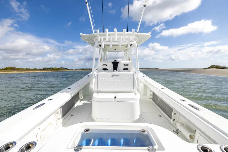 Slide: The Image of 2014 Yellowfin 32 Offshore boat on calm waters under a blue sky. - 23