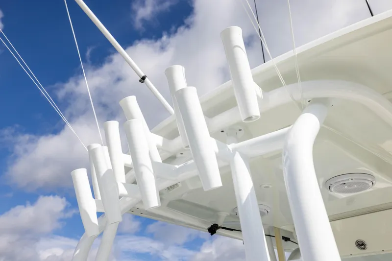 Slide: The Image of Rod holders on a 2014 Yellowfin 32 Offshore boat against a cloudy sky. - 24