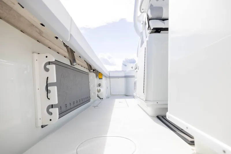 Slide: The Image of 2014 Yellowfin 32 Offshore boat interior with measuring board and seating area. - 26