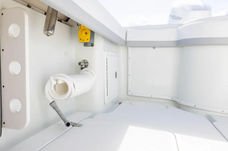 Slide: The Image of 2014 Yellowfin 32 Offshore boat interior with hose and storage compartments. - 27