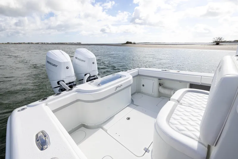 Slide: The Image of 2014 Yellowfin 32 Offshore boat with twin Mercury engines on calm water. - 30