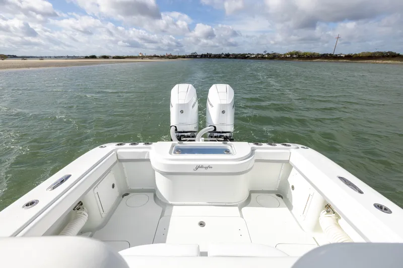 Slide: The Image of 2014 Yellowfin 32 Offshore boat on water, featuring dual engines and spacious deck. - 31
