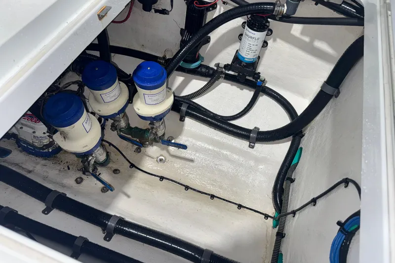 Slide: The Image of 2014 Yellowfin 32 Offshore boat engine compartment with pumps and hoses. - 35