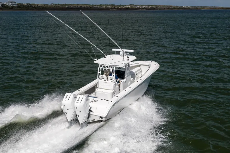 Slide: The Image of 2014 Yellowfin 32 Offshore boat cruising on open water with dual engines. - 5