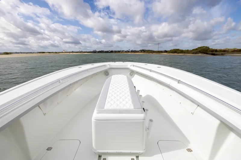 Slide: The Image of 2014 Yellowfin 32 Offshore boat on calm waters under a cloudy sky. - 8
