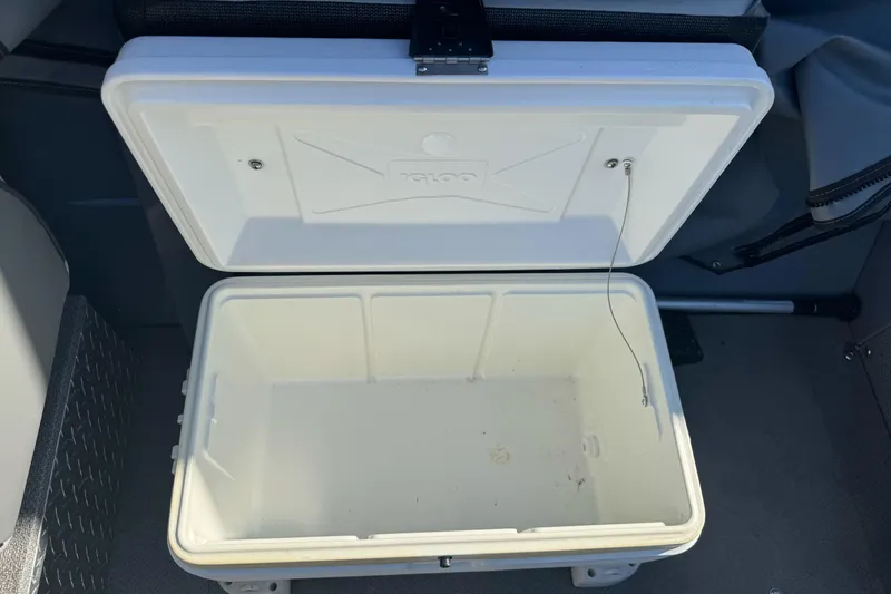 Slide: The Image of Open white cooler inside a 2019 KingFisher 1625 Falcon boat. - 12