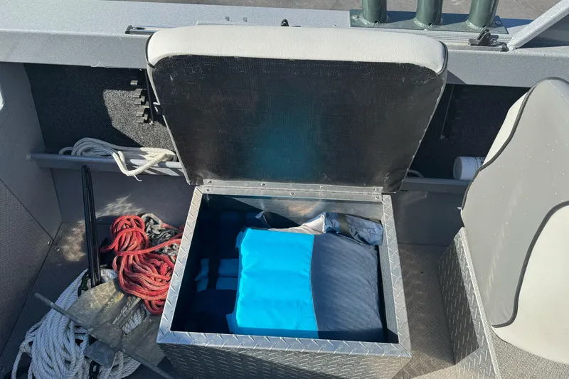Slide: The Image of Storage compartment in a 2019 KingFisher 1625 Falcon boat with ropes and gear. - 13