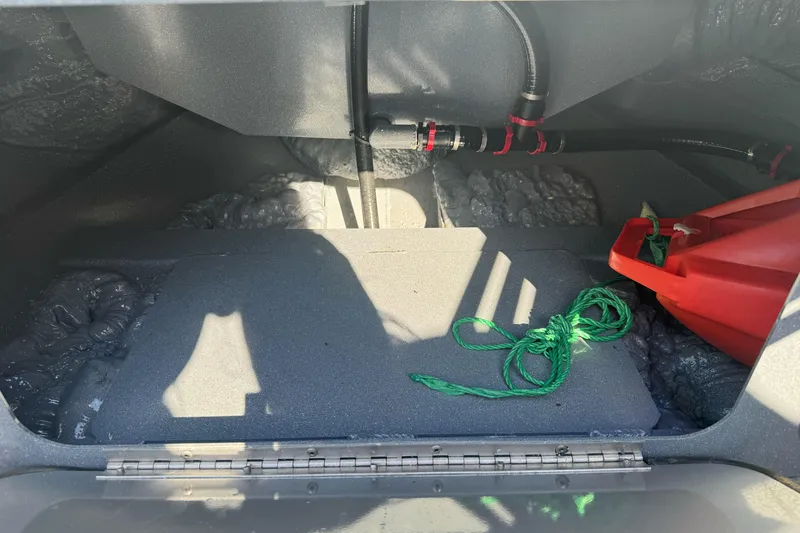 Slide: The Image of Interior view of a 2019 KingFisher 1625 Falcon boat compartment with rope and red container. - 15