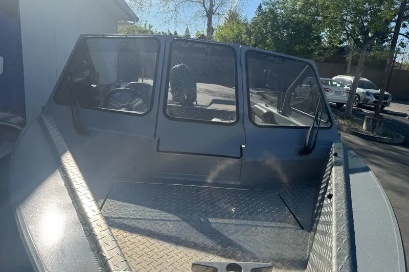 Slide: The Image of 2019 KingFisher 1625 Falcon boat with windshield, parked outdoors. - 5