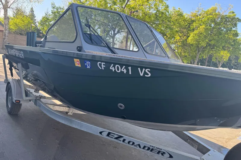 Slide: The Image of 2019 KingFisher 1625 Falcon boat on EZ Loader trailer, parked outdoors. - 6