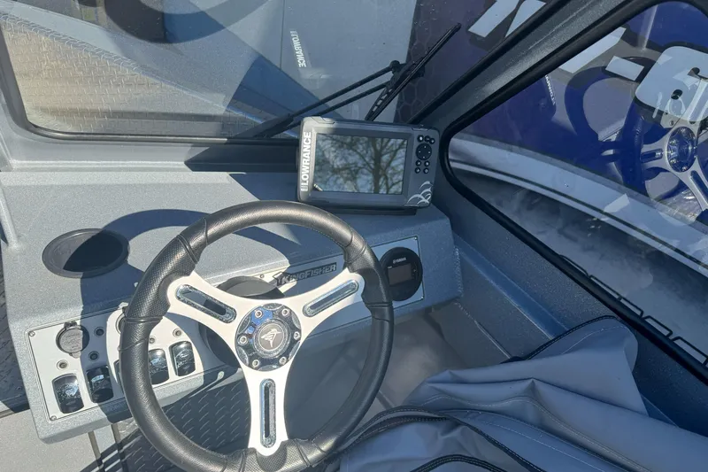Slide: The Image of 2019 KingFisher 1625 Falcon boat dashboard with steering wheel and Lowrance navigation system. - 8