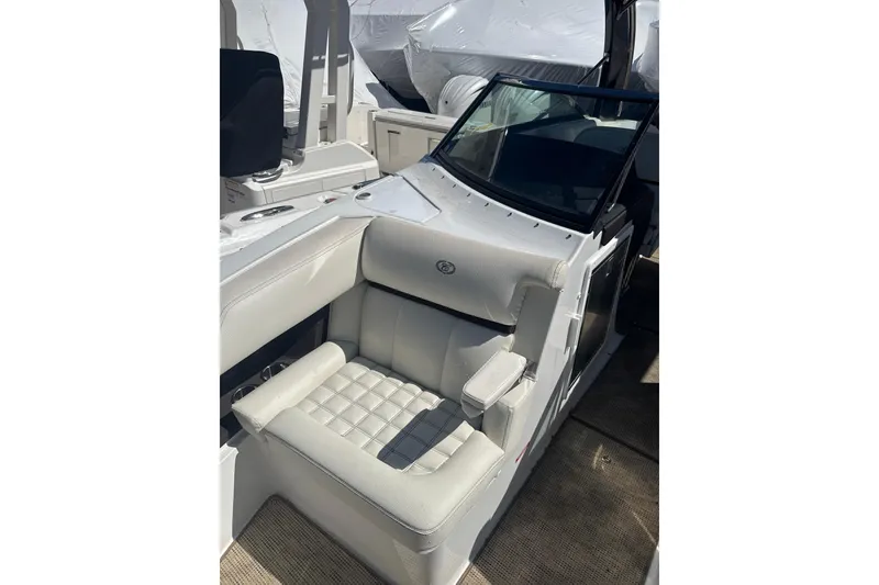 Slide: The Image of 2020 Cobalt R30 boat interior with white cushioned seating and modern design. - 14