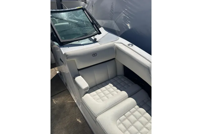 Slide: The Image of 2020 Cobalt R30 boat interior with white cushioned seating and windshield. - 15