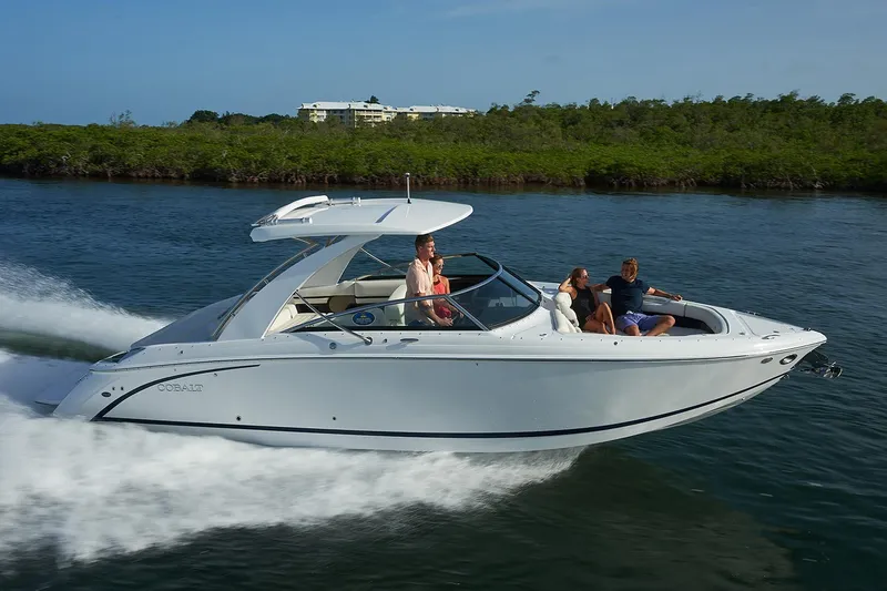 Slide: The Image of Manufacturer Provided Image: 2020 Cobalt R30 boat cruising on water with passengers. - 2