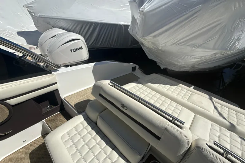 Slide: The Image of 2020 Cobalt R30 boat interior with Yamaha engine, featuring white cushioned seating. - 20