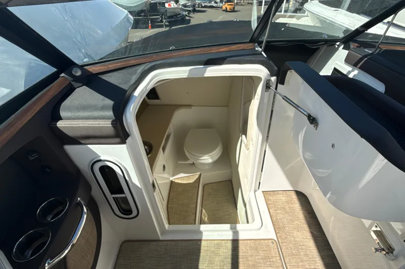 Slide: The Image of Interior view of a 2020 Cobalt R30 boat, featuring a compact onboard restroom. - 22