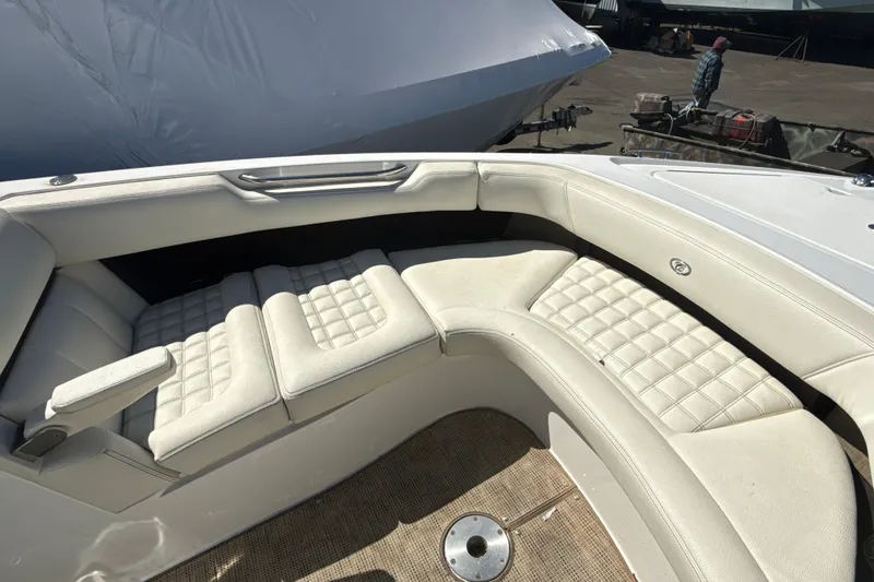 Slide: The Image of 2020 Cobalt R30 boat interior with white seating and wooden table under clear blue sky. - 6