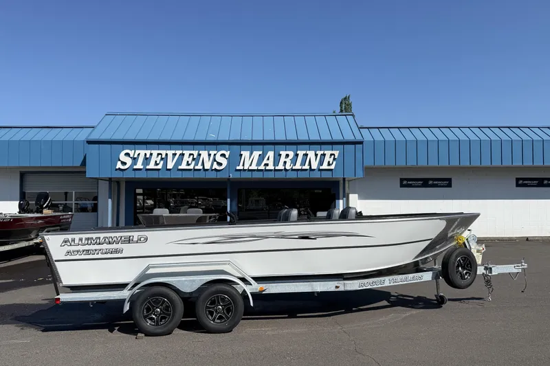 Slide: The Image of 2025 Alumaweld Adventurer 22 boat on trailer at Stevens Marine dealership. - 14