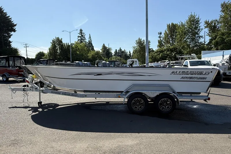 Slide: The Image of 2025 Alumaweld Adventurer 22 boat on trailer in outdoor setting. - 5