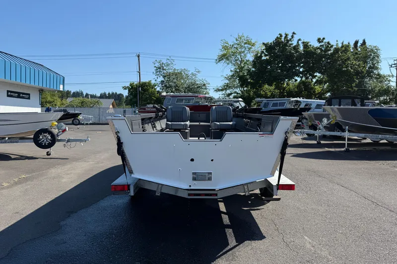 Slide: The Image of 2025 Alumaweld Adventurer 22 boat, rear view, parked outdoors on a sunny day. - 6