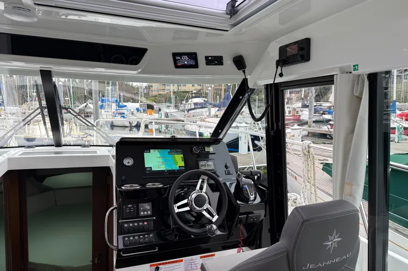 Slide: The Image of Interior view of 2023 Jeanneau NC 1095 boat cockpit with navigation equipment. - 14