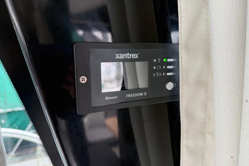 Slide: The Image of Xantrex Freedom X control panel on 2023 Jeanneau NC 1095 boat interior. - 16