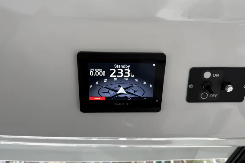 Slide: The Image of Garmin navigation display on 2023 Jeanneau NC 1095 boat dashboard, showing compass and controls. - 17