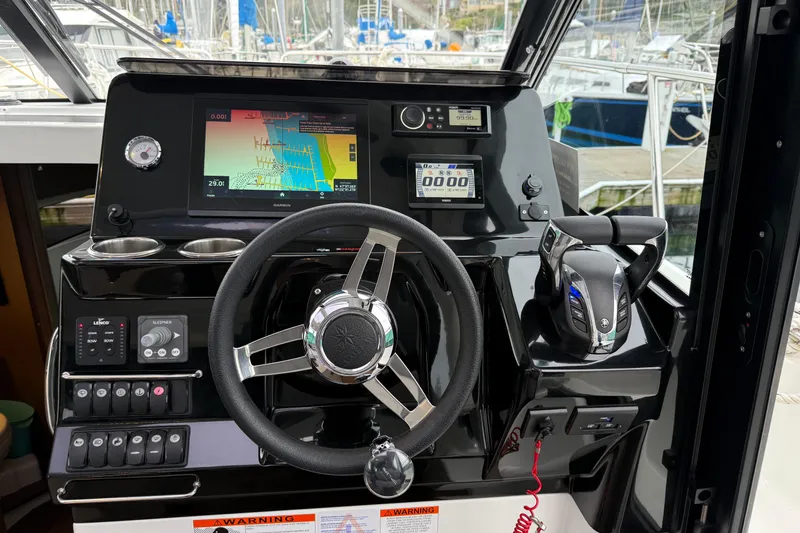 Slide: The Image of Helm of 2023 Jeanneau NC 1095 boat with navigation controls and display. - 19