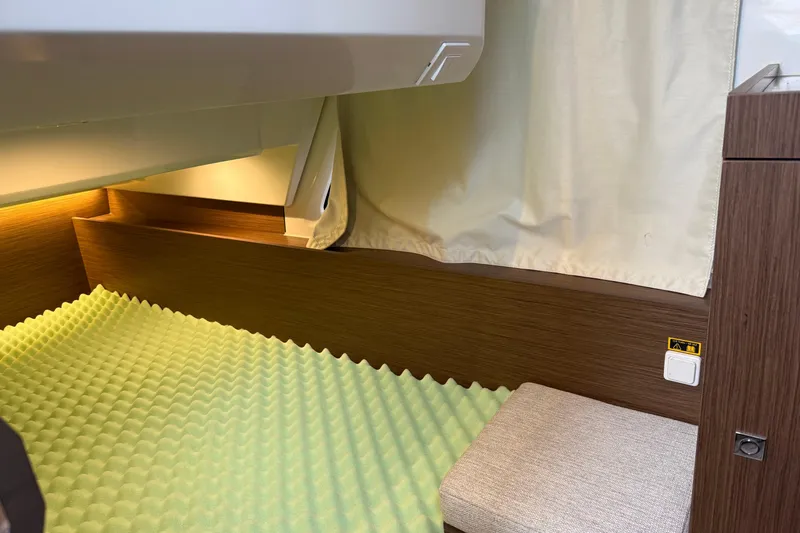 Slide: The Image of Interior cabin of 2023 Jeanneau NC 1095 with foam mattress and wooden finish. - 22