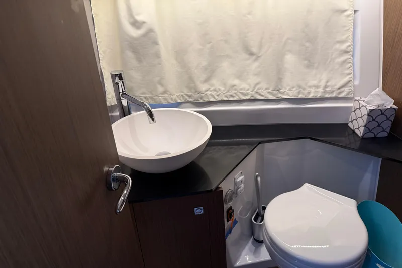 Slide: The Image of Modern bathroom in 2023 Jeanneau NC 1095 boat with sink and toilet. - 25
