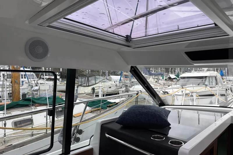 Slide: The Image of Interior view of 2023 Jeanneau NC 1095 yacht with marina background. - 33
