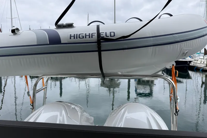 Slide: The Image of 2023 Jeanneau NC 1095 with Highfield inflatable boat on davit system at marina. - 38