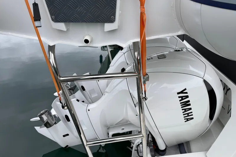 Slide: The Image of Jeanneau NC 1095 boat with Yamaha outboard motor, 2023 model, docked with ladder visible. - 4