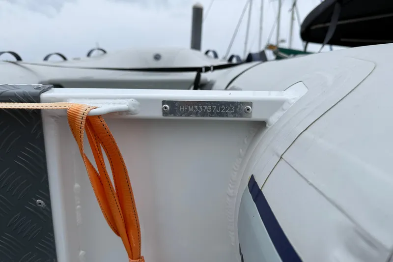 Slide: The Image of 2023 Jeanneau NC 1095 boat detail with identification plate and orange strap. - 6