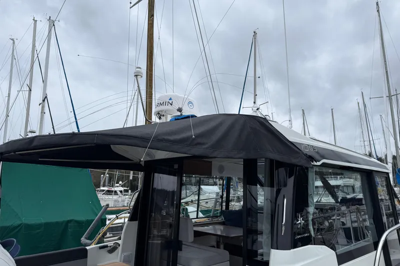 Slide: The Image of 2023 Jeanneau NC 1095 boat docked at marina with overcast sky. - 7
