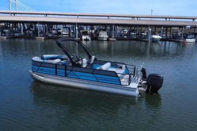 Slide: The Image of 2026 Berkshire CTS Series 24UL pontoon boat docked in a marina, featuring sleek design and modern amenities. - 10