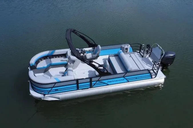 Slide: The Image of 2026 Berkshire CTS Series 24UL pontoon boat on calm water. - 11
