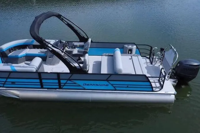 Slide: The Image of 2026 Berkshire CTS Series 24UL pontoon boat on calm water. - 12