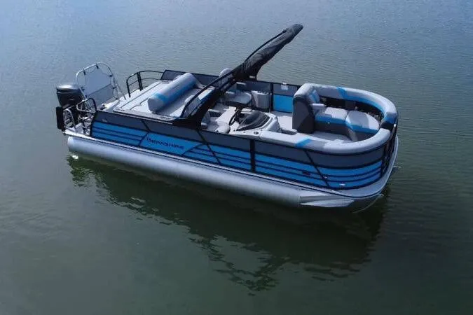Slide: The Image of 2026 Berkshire CTS Series 24UL pontoon boat on calm water, featuring sleek design and modern seating. - 2