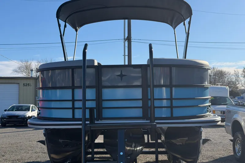 Slide: The Image of 2026 Berkshire CTS Series 24UL pontoon boat with canopy, parked outdoors. - 5
