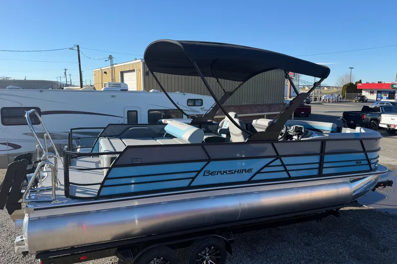 Slide: The Image of 2026 Berkshire CTS Series 24UL pontoon boat with canopy, parked outdoors. - 7