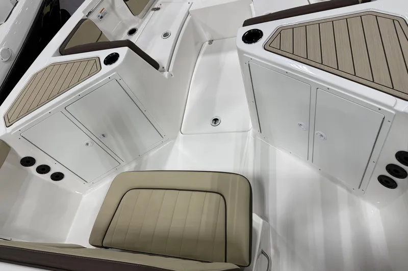 Slide: The Image of 2026 Yamaha Boats 222 FSH Sport interior with beige seating and storage compartments. - 3